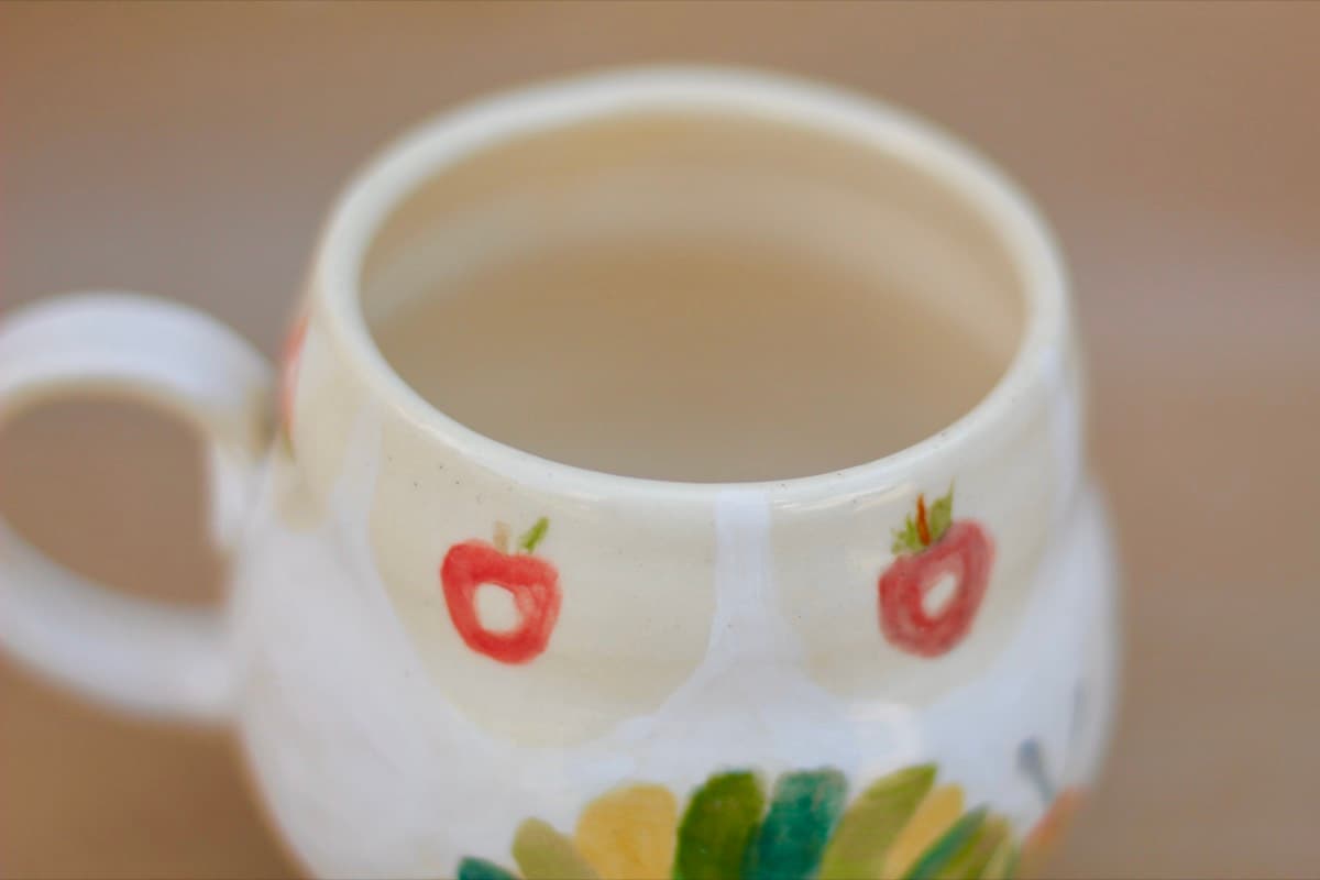 Apple and sunflower mug detail